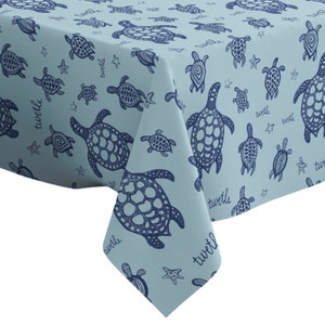 May include: A light blue tablecloth with a repeating pattern of dark blue sea turtles and the word "twirl" throughout.