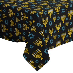 May include: Black tablecloth with a repeating pattern of gold menorahs and blue Star of David symbols.
