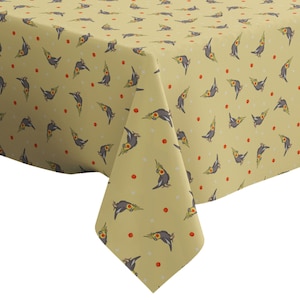 May include: A yellow tablecloth with a repeating pattern of gray and yellow cockatiels and small red dots.
