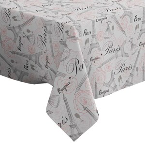 May include: White tablecloth with a repeating pattern of Eiffel Towers, roses, and the words "Paris" and "Bonjour".