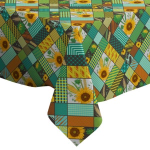 May include: A patchwork tablecloth with a yellow, green, and brown color scheme. The tablecloth features a repeating pattern of sunflowers and corn.