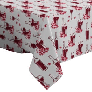 Könnte beinhalten: Weißer Tischdeckenstoff mit einem sich wiederholenden Muster aus roten Weinflaschen und Trauben. Die Flaschen sind schwarz umrandet und mit rotem Wein gefüllt. Die Trauben sind eine Ansammlung kleiner roter Kreise.