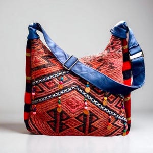 May include: A red, blue, and black patterned shoulder bag with a blue leather strap and colorful beads and coin accents.