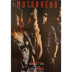 May include: A black and white poster advertising a Motörhead concert in Spain in 1993. The poster features a photo of the band members, with the band's name in red letters at the top. The text "ESPAÑA GIRA '93" is in white letters on a black background. The text "METAL HEAVY ROCK MAGAZINE" is in red and white letters on a black background.