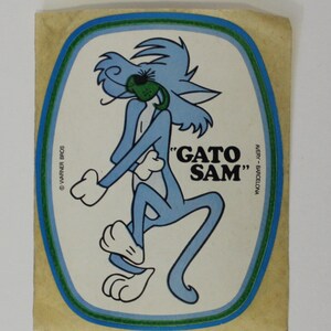 May include: A blue cartoon cat with a green eye patch, labelled "Gato Sam", on a white background with a blue, green and yellow border.