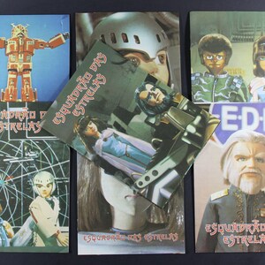 May include: A collection of six vintage trading cards featuring characters and a robot from the Brazilian science fiction television series "Esquadrão das Estrelas". The cards feature the title of the series, "Esquadrão das Estrelas", and the acronym "EDF" in a circle.