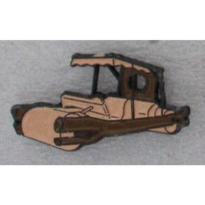 May include: A brown metal pin of a cartoon vehicle with a tan body and a brown canopy. The vehicle has two large wheels and a smaller wheel in the back.