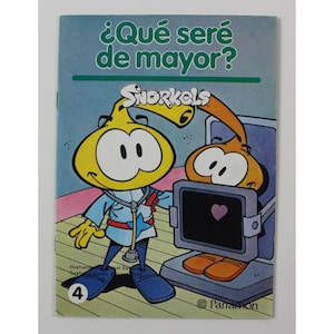Puede incluir: Portada de libro infantil vintage con el título "¿Qué seré de mayor?" y personajes de Snorkels. La ilustración muestra un personaje de dibujos animados amarillo con bata de médico y estetoscopio, interactuando con un ordenador que muestra un corazón.