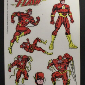 May include: A sheet of stickers featuring the superhero Flash. The stickers are red and yellow and depict the Flash in various poses. The sheet is titled "Los Superheroes Flash" and includes the text "Si las figuras pierden adherencia, frotar con un paño de lana."  The sheet also includes the text "Mello Smello Star Toys S.A. Campe, 22 Barcelona MADE IN USA" and "ATENCIÓN: Manteiga esta lámina fuera del alcance de los niños menores de tres años."