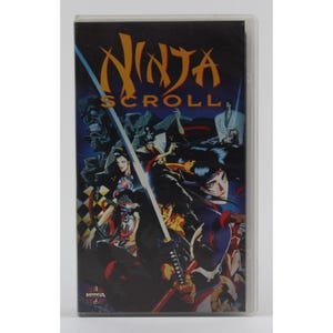 May include: A VHS tape with a colorful image of characters from the anime "Ninja Scroll". The title "Ninja Scroll" is printed in large, bold letters on the front of the tape.