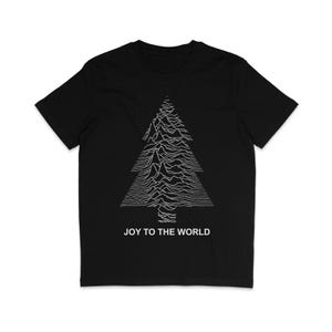 May include: Black t-shirt with a white graphic of a Christmas tree in a topographic style. The words "JOY TO THE WORLD" are printed in white beneath the tree. A short-sleeved, crew neck tee.