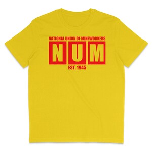 May include: Yellow t-shirt with red text that reads "NATIONAL UNION OF MINEWORKERS NUM EST. 1945"