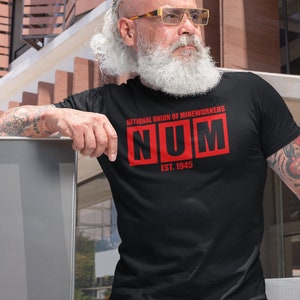 May include: A black t-shirt with a red graphic that says "National Union of Mineworkers NUM Est. 1945".
