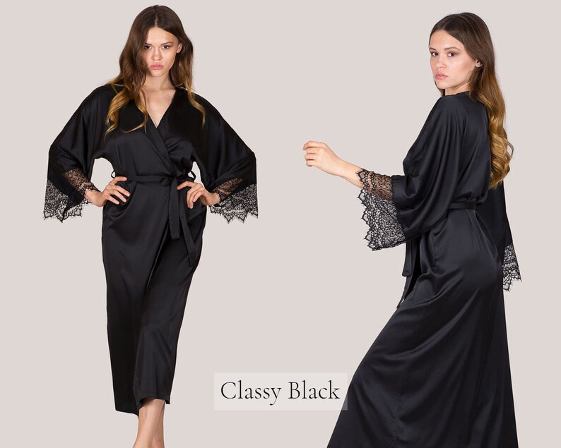 May include: A black satin robe with lace trim on the sleeves. The robe is tied at the waist with a matching sash. The text "Classy Black" is visible in the image.