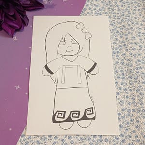 May include: A black and white line art drawing on a rectangular white card featuring a character with long hair, a bow, a short-sleeved top, and a skirt with a geometric pattern along the bottom hem. The character has a neutral facial expression.