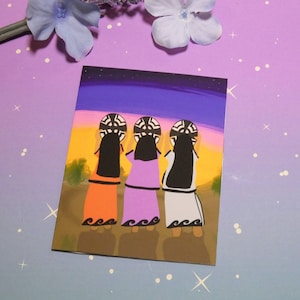 May include: Three women stand back to back, each holding a black and white patterned circular object above their heads. They are wearing colorful dresses and have long black hair. The background is a sunset sky with stars.