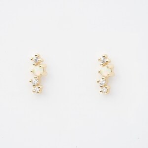 May include: A pair of gold earrings with a small opal and three tiny diamonds each.