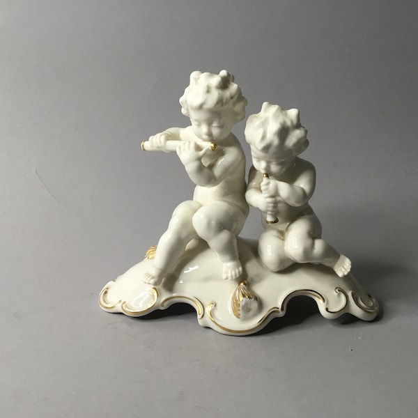 Porcelain figurines of putti playing by Hutschenreuther