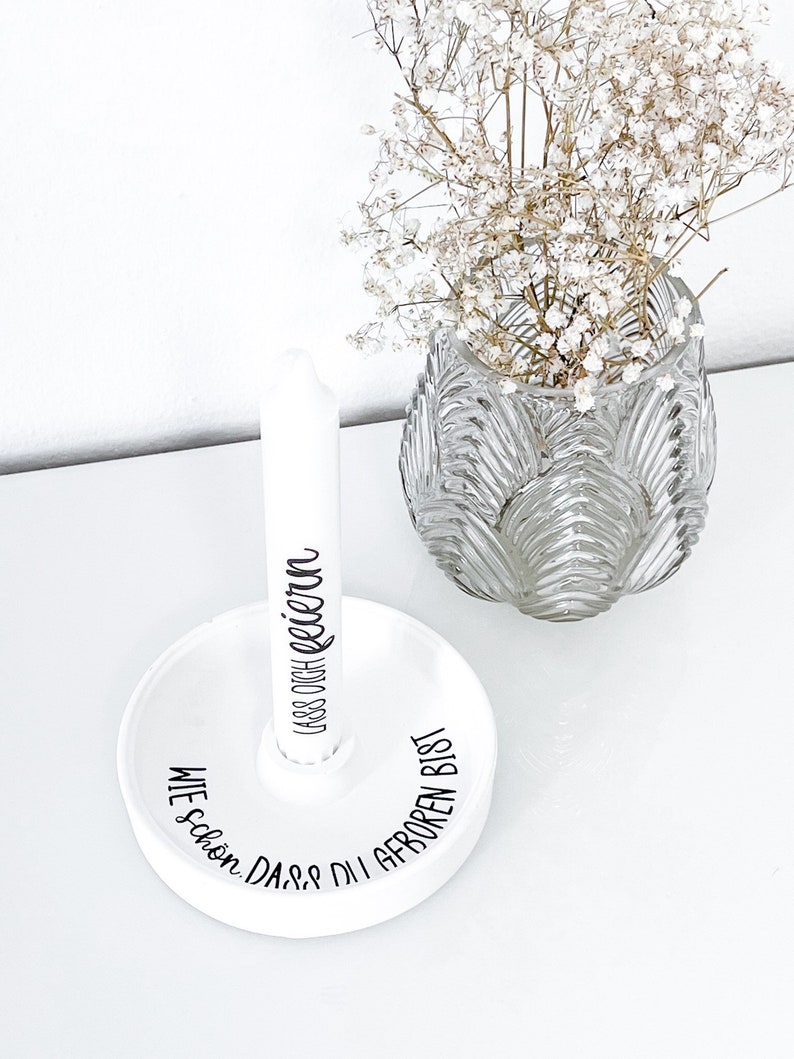 May include: White ceramic candle holder with the text "Wie sch&ouml;n, dass du geboren bist" and "Lass dich feiern" in black lettering.