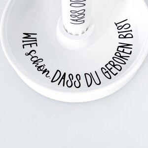 May include: White ceramic dish with black text that reads "Wie sch&ouml;n, dass du geboren bist".
