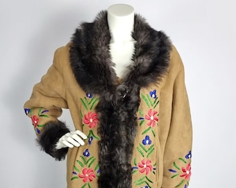May include: A long brown suede coat with a faux fur collar and cuffs. The coat is embroidered with colourful flowers.