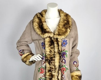 May include: A long, brown suede coat with a faux fur collar and cuffs. The coat is embroidered with colorful flowers.