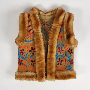 May include: A brown faux fur vest with a suede front featuring colourful embroidered floral designs.