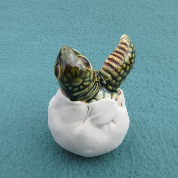 One-Flipper Hatchling (3 of 7): Life-size, hand-crafted ceramic sea turtle hatchling with one flipper and head emerged from egg