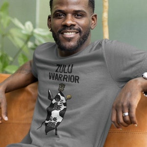 May include: A grey t-shirt with a black and white illustration of a Zulu warrior with the text "Zulu Warrior" printed on the front.