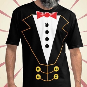 May include: A black t-shirt with a tuxedo printed on the front. The tuxedo has a red bow tie, white shirt, and gold buttons.