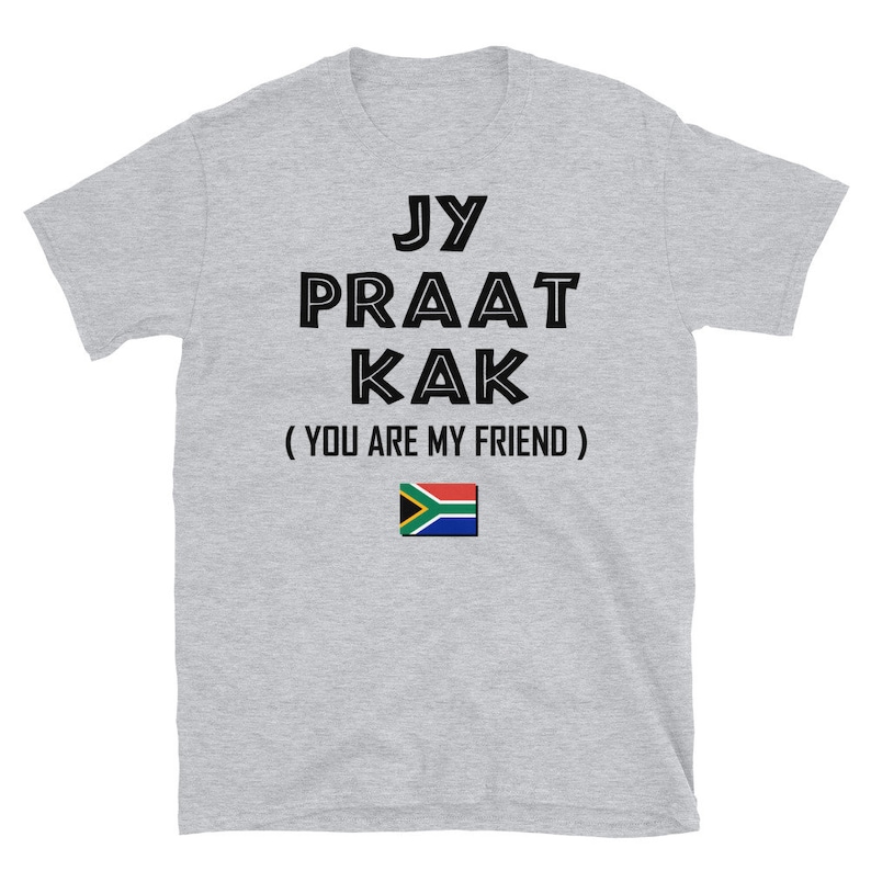May include: Gray t-shirt with black text that reads "Jy Praat Kak (You Are My Friend)" and a South African flag.