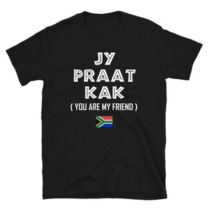 May include: Black t-shirt with white text that reads "Jy Praat Kak (You Are My Friend)" and a South African flag.