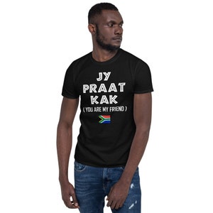 May include: A black t-shirt with white text that reads "Jy Praat Kak (You Are My Friend)" and a South African flag.