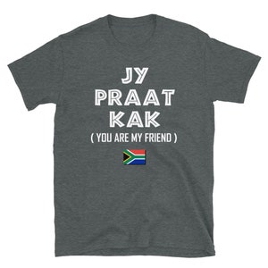 May include: A dark gray t-shirt with white text that reads "Jy Praat Kak (You Are My Friend)" and a South African flag.