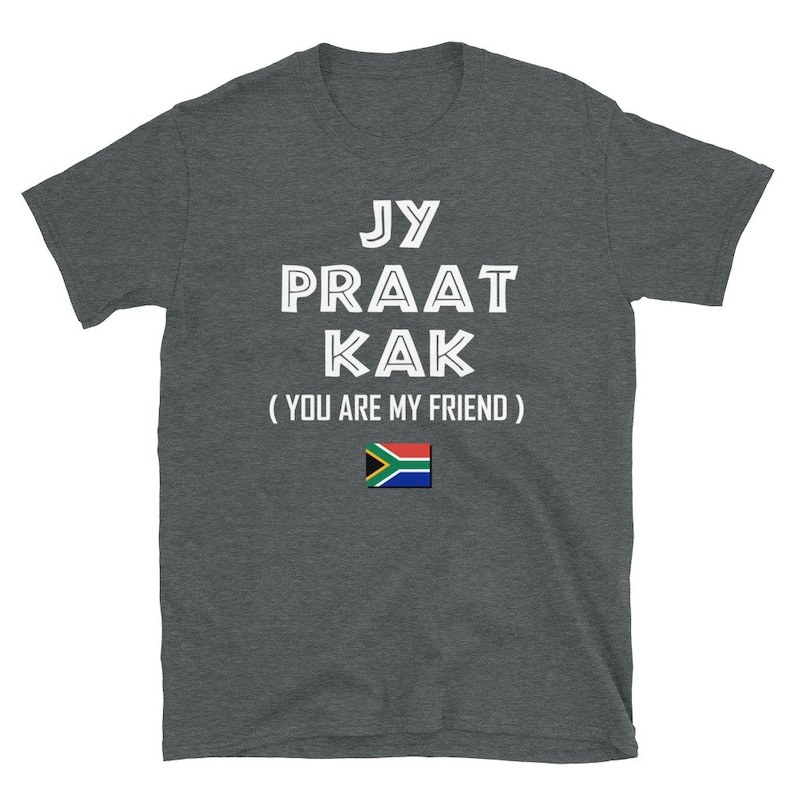 May include: A dark gray t-shirt with white text that reads "Jy Praat Kak (You Are My Friend)" and a South African flag.