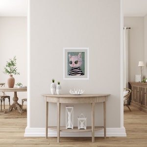 May include: A framed painting of a white cat wearing round sunglasses and a black and white striped sweater. The cat is looking to the left of the image. The background is a light green color.