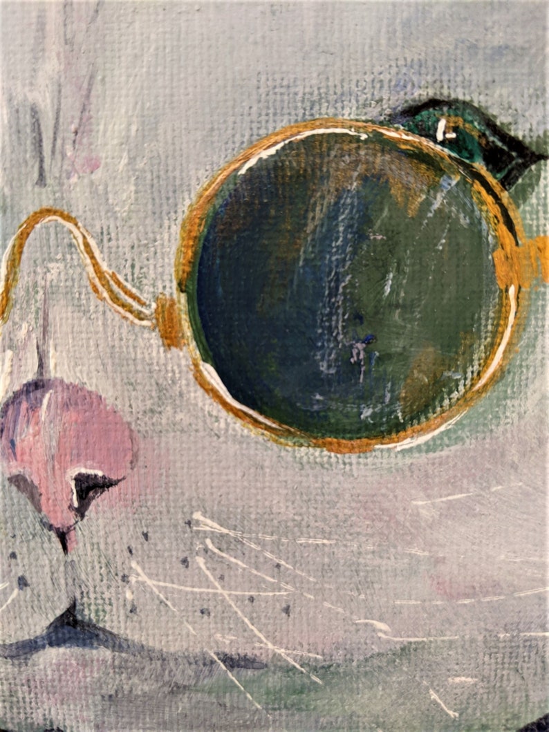 May include: A close-up of a white cat's face with a single round, gold-rimmed eyeglass lens. The lens is green and has a gold rim. The cat's nose is pink and its whiskers are visible.