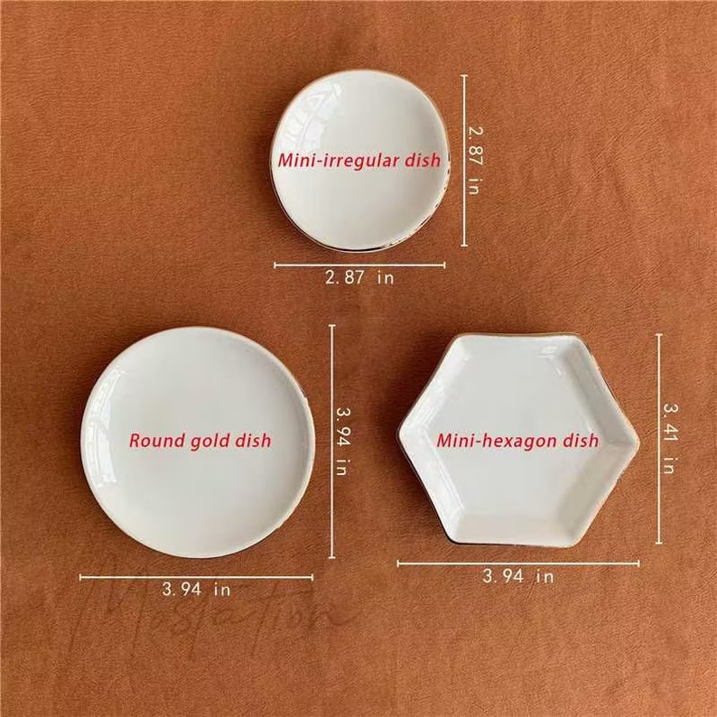 May include: Three white dishes with gold rims. A mini-irregular dish measuring 2.87 inches by 2.87 inches, a round gold dish measuring 3.94 inches in diameter, and a mini-hexagon dish measuring 3.94 inches by 3.41 inches.
