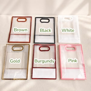 May include: Six rectangular transparent plastic gift bags with die-cut handles, arranged in two rows. The bags feature colored borders in brown, black, white, gold, burgundy, and pink, with the corresponding color names printed on each bag.