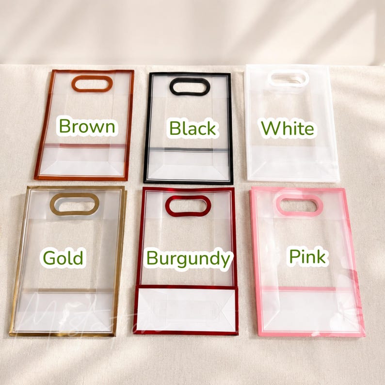 May include: Six rectangular transparent plastic gift bags with die-cut handles, arranged in two rows. The bags feature colored borders in brown, black, white, gold, burgundy, and pink, with the corresponding color names printed on each bag.