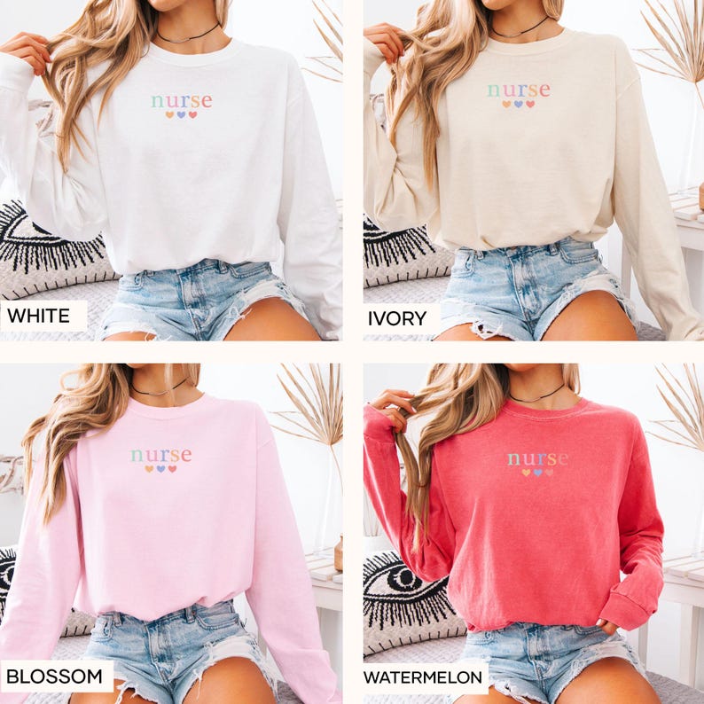 May include: Four long-sleeved sweatshirts in white, ivory, blossom pink, and watermelon red. Each sweatshirt has the word "nurse" embroidered in pastel colors above three hearts. The sweatshirts are displayed on a bed.