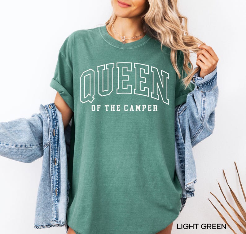 May include: A light green t-shirt with the text "QUEEN OF THE CAMPER" in white.