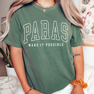 May include: A green t-shirt with white text that reads "PARAS MAKE IT POSSIBLE".
