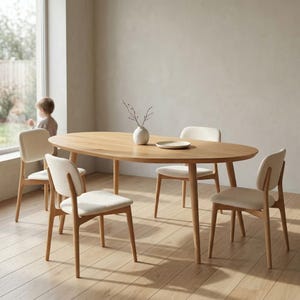 May include: An oval wooden dining table with four matching chairs. The table is light brown and has a smooth surface. The chairs have light-colored upholstered seats and backs. A small white vase and plate are on the table.