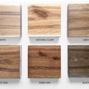 May include: Six wood samples in different colours: white, natural clear, grey, rustic oak, dark oak, and black. The samples are arranged in two rows of three.