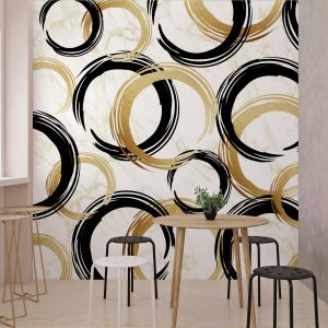 May include: Abstract wallpaper with a white marble background and overlapping black and gold circles. The circles are painted in a brushstroke style.