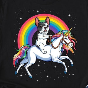 May include: Black t-shirt with a graphic of a French bulldog riding a unicorn with a rainbow in the background.