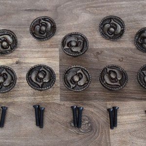 May include: Ten antique-style cabinet knobs with a dolphin design in a silver finish. Each knob is accompanied by two screws for installation.