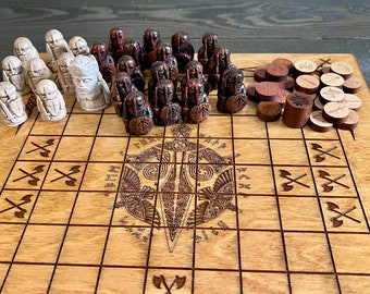 May include: A wooden Viking chess set with brown and white pieces. The board is made of wood and has a carved design in the center. The pieces are arranged in a starting position.