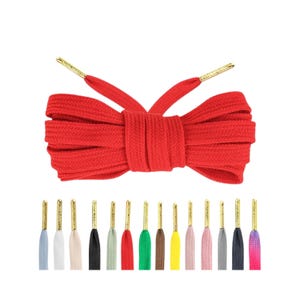 May include: Red shoelaces with gold aglets. The laces are made of a flat, woven material and are tied in a bow. The laces are shown against a white background.